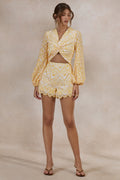 Ksenia | Lemon and White Broderie Plunge-Neck Romper With Twist Detail